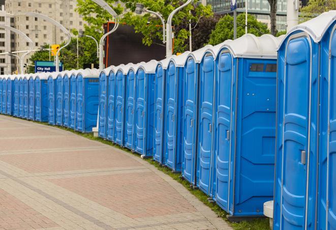 portable restrooms stationed outside of a high-profile event, with attendants available for assistance in Baltic